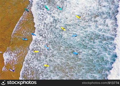 Aerial from surfers getting surfing lessons at the atlantic ocean