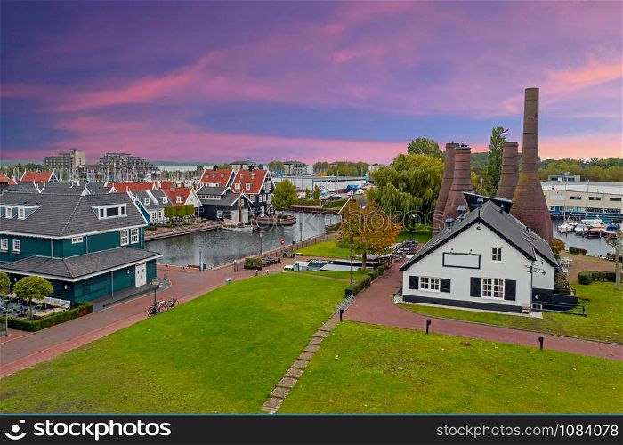 Aerial from traditional brick factory and houses in Huizen the Netherlands at sunset