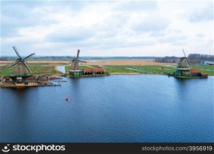 Aerial from traditional windmills in a typical dutch landscape at Zaanse Schans in the Netherlands