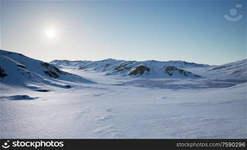 Aerial Landscape of snowy mountains and icy shores in Antarctica