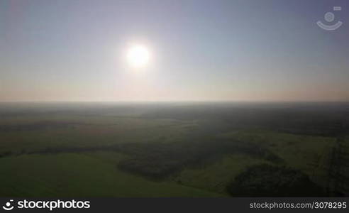 Aerial landscape with green woods and fields. Vast expanses of Russian nature in the light of bright shining sun