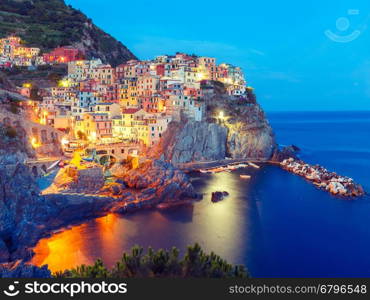 Aerial night view of Manarola fishing village, seascape in Five lands, Cinque Terre National Park, Liguria, Italy.