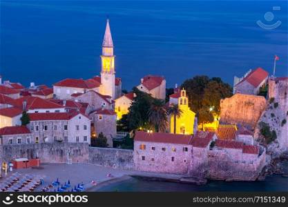 Aerial night view of Saint Ivan and Holy Trinity churches in Old Town of Montenegrin town Budva on the Adriatic Sea, Montenegro. Old Town of Budva, Montenegro