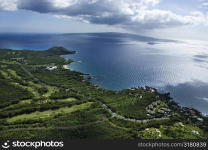 Aerial of coastline with Pacific ocean with island in background in Maui, Hawaii.