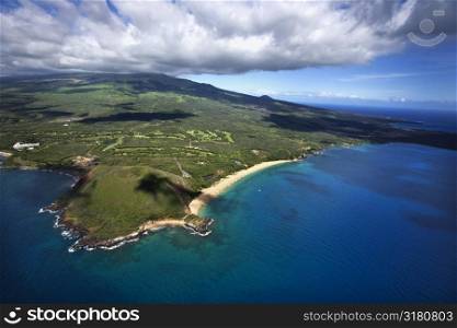Aerial of coastline with sandy beach and crater and Pacific ocean in Maui, Hawaii.