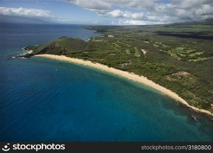 Aerial of coastline with sandy beach and Pacific ocean in Maui, Hawaii.