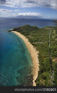 Aerial of coastline with sandy beach and Pacific ocean in Maui, Hawaii.