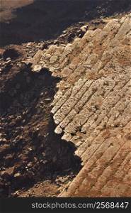 Aerial of deteriorating rock cliff in high desert of Utah, USA.