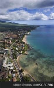 Aerial of Maui, Hawaii coastline with beach, road and buildings.