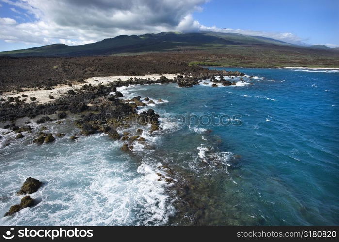 Aerial of Pacific ocean and Maui, Hawaii coast with lava rocks.