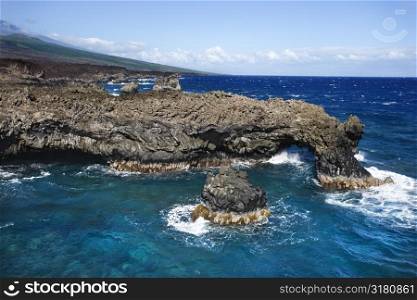 Aerial of Pacific ocean and Maui, Hawaii coast with lava rocks.