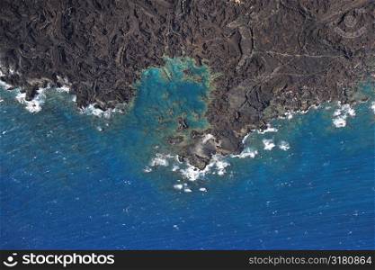 Aerial of Pacific ocean and Maui, Hawaii coast with lava rocks.