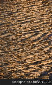Aerial of rippled Atlantic ocean water with sun reflection.