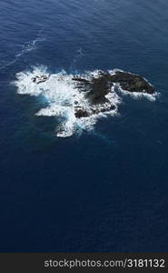 Aerial of rock in Pacific ocean off coast of Maui, Hawaii.