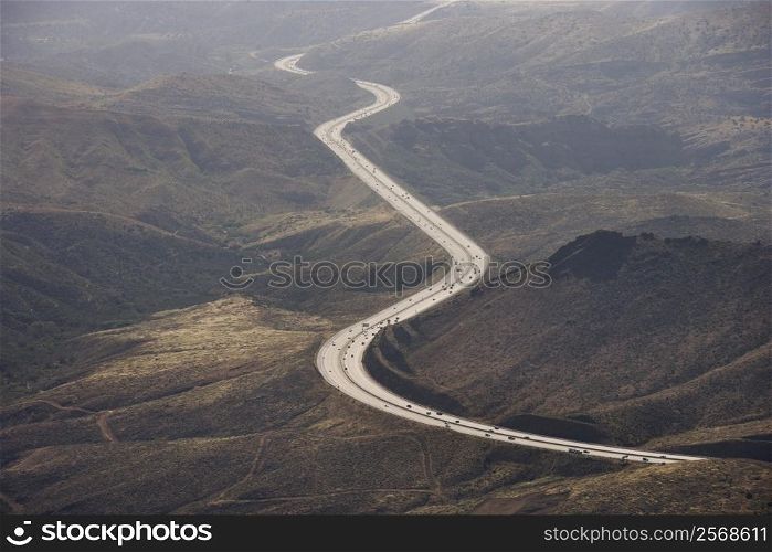 Aerial of Route 14 with traveling vehicles through rural California landscape, USA.