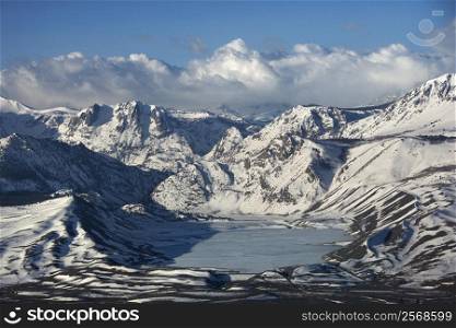 Aerial of snowy mountain landscape with frozen lake in Inyo National Forest, California, USA.