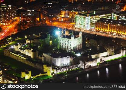 Aerial overview of London city with the Tower fortress at night