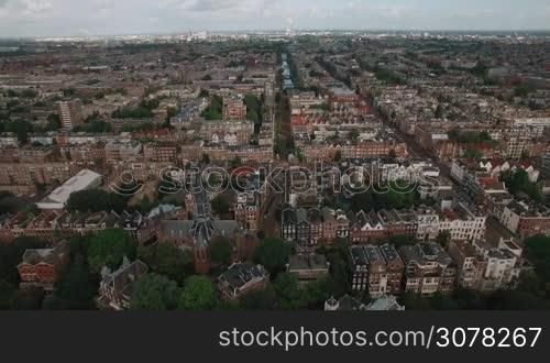 Aerial - Panorama of Amsterdam with lots of typical Dutch houses, streets and Vondel Church