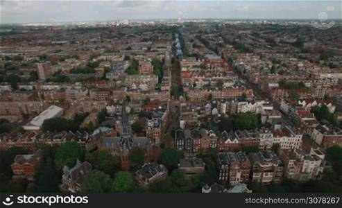 Aerial - Panorama of Amsterdam with lots of typical Dutch houses, streets and Vondel Church