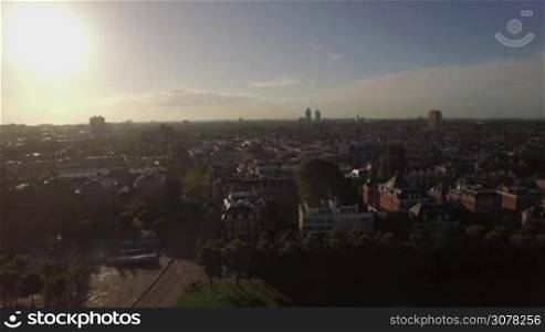 Aerial panorama of Amsterdam with streets and houses in bright sunlight. Dutch capital cityscape