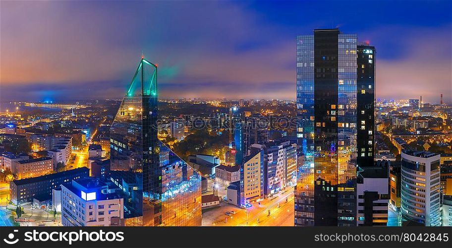 Aerial panorama of modern business financial district with tall skyscraper buildings illuminated at night, Tallinn, Estonia