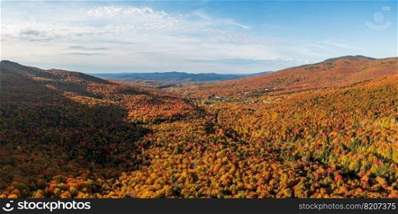 Aerial panorama of the valley with Smugglers Notch vacation and skiing resort in the fall. Aerial view of Smugglers Notch resort in the fall