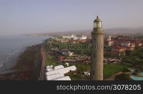 Aerial panorama of tourist town and resort areas on Gran Canaria coast, Maspalomas Lighthouse in the foreground