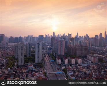 Aerial panorama view of skyscraper and high-rise office buildings in Shanghai Downtown, China at sunset. Financial district and business centers in smart city in Asia.