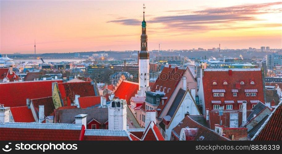 Aerial panoramic cityscape with old town hall spire and red roofs at sunrise, Tallinn, Estonia. Aerial cityscape of Tallinn, Estonia