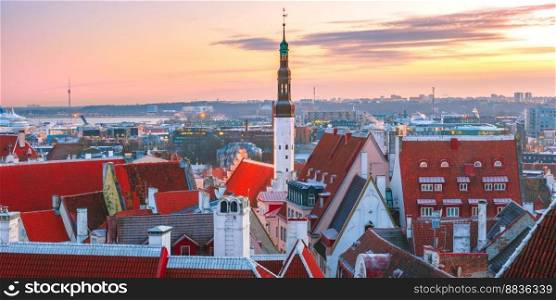 Aerial panoramic cityscape with old town hall spire and red roofs at sunrise, Tallinn, Estonia. Aerial cityscape of Tallinn, Estonia