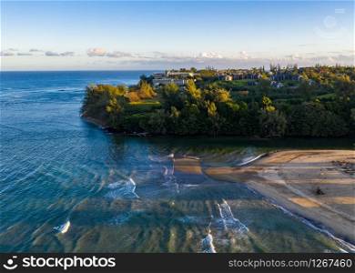 Aerial panoramic image at sunrise off the coast over Hanalei Bay and Princeville on Hawaiian island of Kauai. Aerial drone shot of Hanalei bay and Princeville on the north shore of Kauai in Hawaii