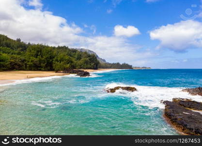 Aerial panoramic image off the coast over Lumaha&rsquo;i beach on Hawaiian island of Kauai with Na Pali mountains behind. Aerial drone shot of Lumahai Beach on the north shore of Kauai in Hawaii