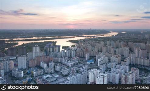 Aerial panoramic photography from the drone, bird&rsquo;s eye view to Pozniaky district and view to right bank Dnieper with bridges across it and the modern building of the city Kiev.. A bird&rsquo;s eye view, aerial panoramic view from drone to the Darnyts&rsquo;kyi district of Kiev, Ukraine and view to the right bank of Dnieper at sunset in the summer.