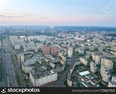 Aerial panoramic photography from the drone, bird’s eye view to Pozniaky district, Mykoly Bazhana Ave, modern building of the city Kiev at sunset in the summer.. A bird’s eye view, aerial panoramic view from drone to the Darnyts’kyi district of Kiev, Ukraine and the left bank of Dnieper.
