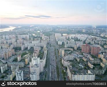 Aerial panoramic photography from the drone, bird’s eye view to Pozniaky district and view to right bank Dnieper with bridges across it and the modern building of the city Kiev.. A bird’s eye view, aerial panoramic view from drone to the Darnyts’kyi district of Kiev, Ukraine and view to the right bank of Dnieper at sunset in the summer.