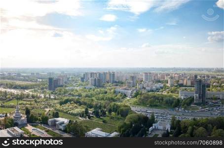 Aerial panoramic view from the drone to Kyiv Natsional University Tarasa Shevchenka, National Expo Center of Ukraine and city district with modern buildings and urban infrastructure.. The panoramic bird’s eye view shooting from drone to modern city district with urban infrastructure and residential buildings of Kiev, Ukraine at summer sunset.