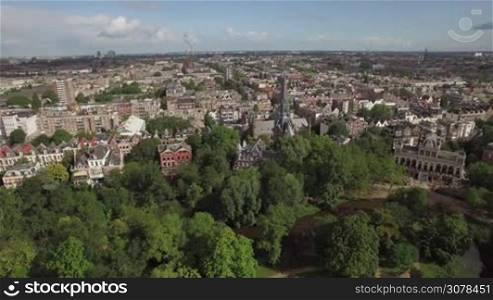 Aerial panoramic view of center of Amsterdam against blue sky with clouds at summer, Netherlands