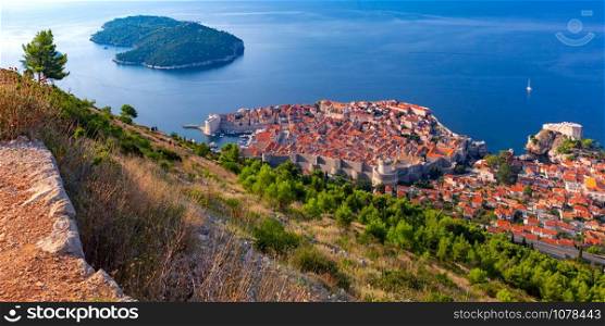 Aerial panoramic view of Lokrum island and Old Town of Dubrovnik with City wall, towers, forts and Old Harbour in Dubrovnik, Croatia. Old Town of Dubrovnik, Croatia
