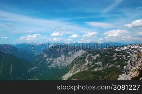 Aerial panoramic view of mountains with pine woods forest. sun flare in summer day in Austria, Obertraun