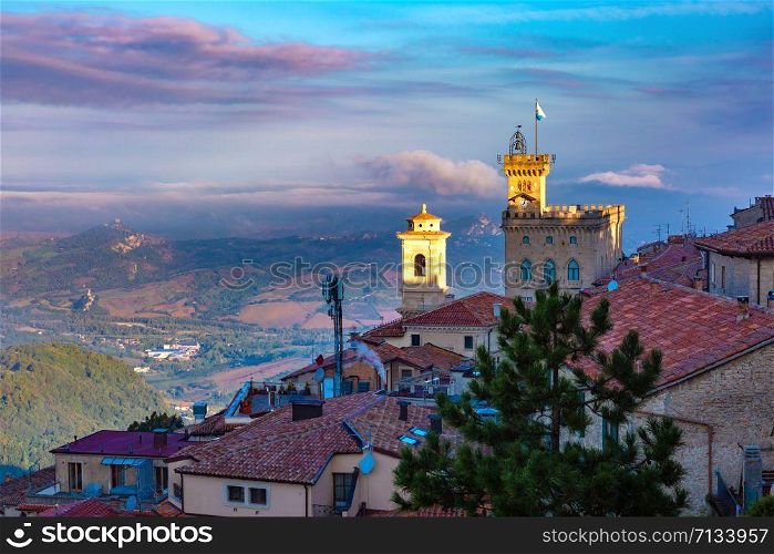 Aerial panoramic view of San Marino cityscape with Palazzo Pubblico, town hall of the City of San Marino at sunrise, Republic of San Marino. San Marino at sunrise