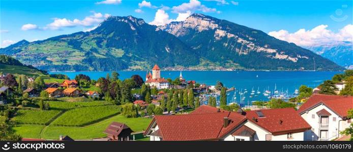 Aerial panoramic view of Spiez town with Church and Castle on the shore of Lake Thun in the Swiss canton of Bern at sunset, Spiez, Switzerland.. Spiez Church and Castle, Switzerland