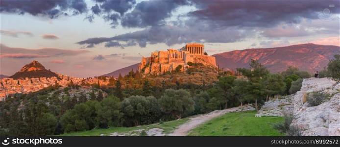 Aerial panoramic view of the Acropolis Hill with Parthenon and Mount Lycabettus at gorgeous sunset in Athens, Greece. Acropolis Hill and Parthenon in Athens, Greece