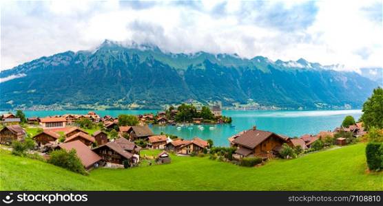 Aerial panoramic view of the peninsula and former castle and Lake Brienz in swiss village Iseltwald, Switzerland. Swiss village Iseltwald, Switzerland