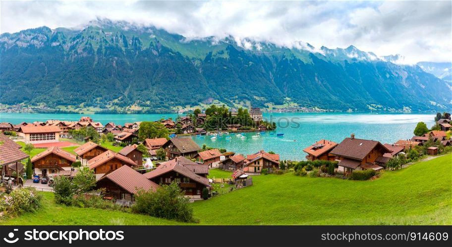 Aerial panoramic view of the peninsula and former castle and Lake Brienz in swiss village Iseltwald, Switzerland. Swiss village Iseltwald, Switzerland