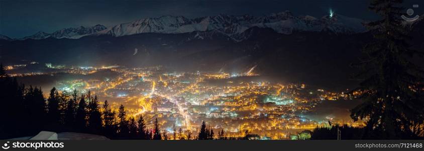 Aerial panoramic view of Zakopane and Tatry mountains at night, Poland