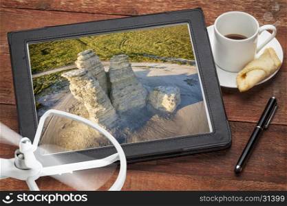 aerial photography concept - reviewing aerial pictures of the Castle Rock landmark in Kansas on a digital tablet with a drone rotor and coffee, screen picture copyright by the photographer