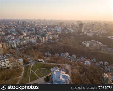 Aerial photography from the drone to the Central House of Artists, Trading house, Peizazhna Alley and districts with chuches and old building houses in the city of Kiev in Ukraine a shot at sunset in the summer.. Panoramic aerial view from the drone, a view of the bird&rsquo;s eye view of the the central historical part of the city of Kiev, Ukraine, with old buildings of the city.