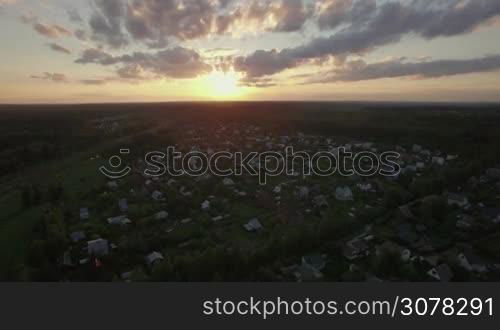 Aerial scene of countryside at sunset. Russian dacha community