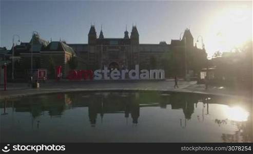 Aerial shot of Art Square with pond and I amsterdam slogan in front of Rijksmuseum, Netherlands. View in bright sunlight