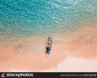 Aerial shot of Couple relaxing in a kayak Summer seascape beach and blue sea water Top view from drone